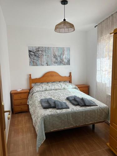 a bedroom with a bed with two pillows on it at Casa Sol y Valle in Sotillo de la Adrada