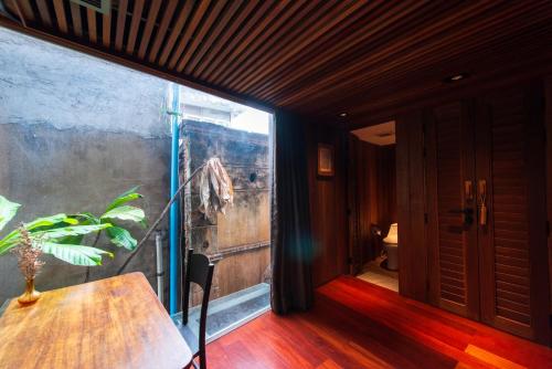a room with a table and a large window at Na Tanao 1969 in Bangkok