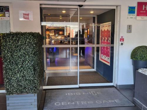 an entrance to a store with a glass door at ibis Nice Centre Gare in Nice
