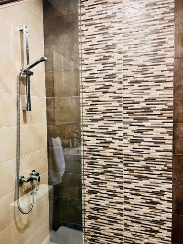 a bathroom with a shower with a glass door at Lovely Aparthotel in Tsaghkadzor in Tsaghkadzor