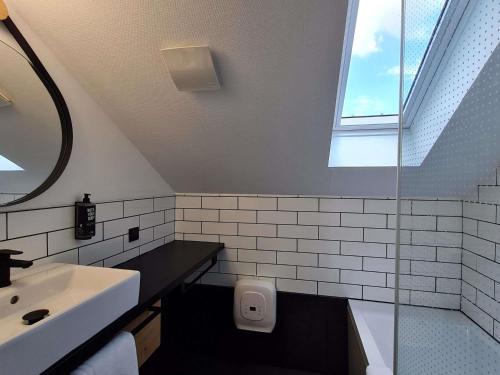 a bathroom with a sink and a toilet and a window at Ibis Pau Centre in Pau