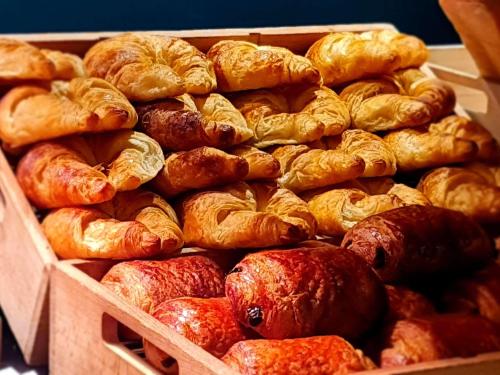 a box filled with lots of croissants and other pastries at Ibis Pau Centre in Pau