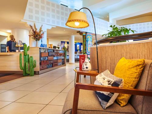 a store lobby with a couch and a lamp at ibis Paris La Villette Cité des Sciences 19ème in Paris