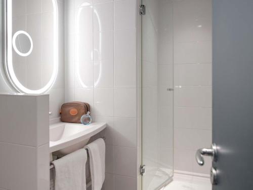 a white bathroom with a sink and a shower at ibis Rueil-Malmaison Centre in Rueil-Malmaison