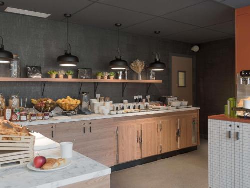 a kitchen with a counter with food on it at ibis Rueil-Malmaison Centre in Rueil-Malmaison