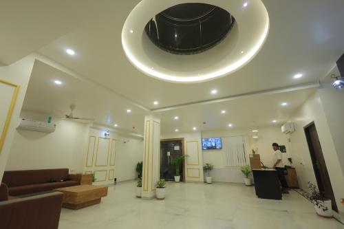 a man standing in a living room with a ceiling at Jeel Pearl Hotel in Udaipur