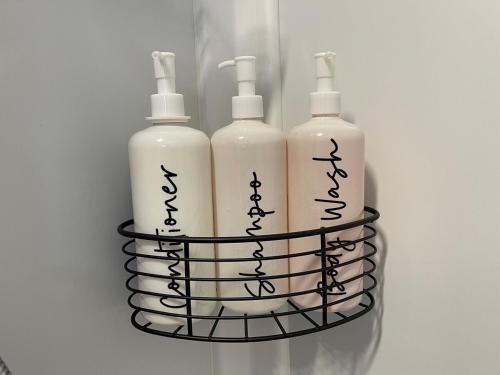 three bottles in a rack on a refrigerator at Wannanup Retreat in Wannanup