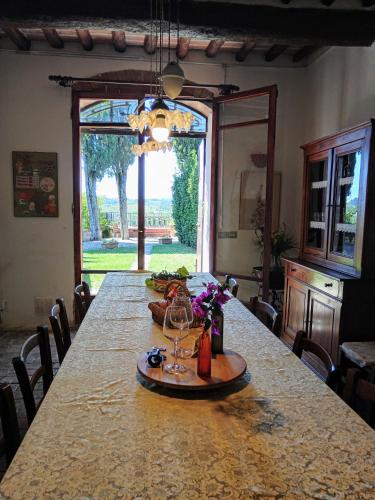 a table in a room with a large table with wine glasses at Villa Remignoli in San Gimignano