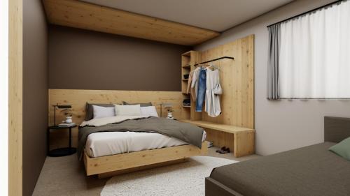 a bedroom with a bed with a wooden headboard at El Giof Alpine Home in Pellizzano
