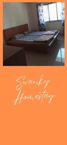 a picture of a bedroom with a bed with the words sympathy improvement at Swanky Midtown Holiday Inn 2BHK in Kolhapur