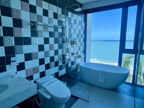 a bathroom with a tub and a toilet and a sink at Hualien S.E.A. B&B in Hualien City