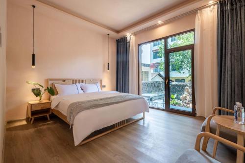 Postel nebo postele na pokoji v ubytování Shanju Bieyuan Homestay (Yangshuo Yulonghe Branch)