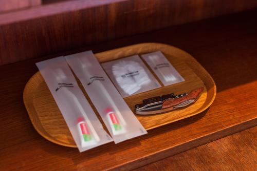 a wooden table with three packets ofiversaryvation at Na Tanao 1969 in Bangkok