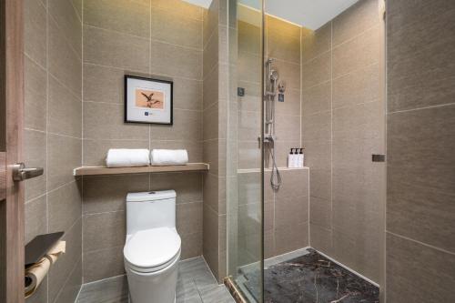a bathroom with a toilet and a shower at Mehood Lestie International Hotel Shenzhen Science and Technology Park Hi-Tech Central Metro Station Branch in Shenzhen