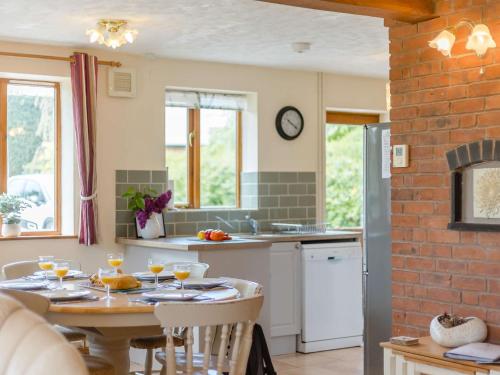 a kitchen with a table with wine glasses on it at 3 bed in Worcester CC037 in Clifton upon Teme