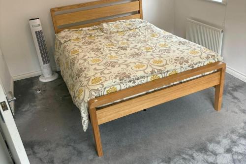 a bed in a room with a bed frame with a blanket at House - Sleeps 5 Private Parking & Pets Allowed in Manchester