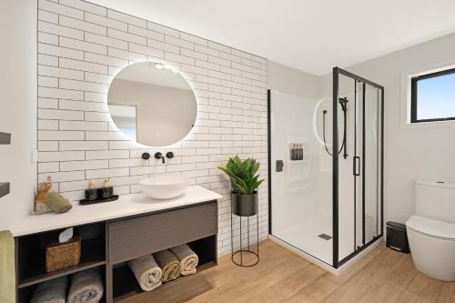 a bathroom with a sink and a mirror at Bellamy Station - Luxury on the Clutha Gold Trail in Evans Flat