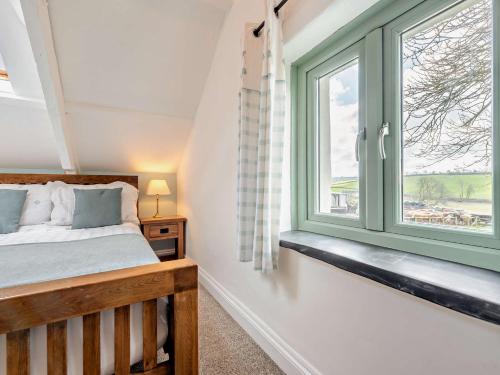 a bedroom with a bed and a window at 2 Bed in Narberth 72864 in Whitland
