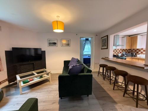 a living room with a couch and a bar at The River Cottage 3 Bedroom retreat in Limerick