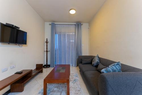 a living room with a couch and a table at Daisy Hotel in Addis Ababa