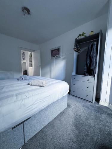 a bedroom with a large white bed and a dresser at Thornleigh Guest House - Free ON STREET Parking in Windermere
