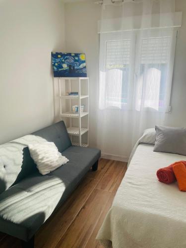 a living room with two beds and a couch at La Casita de Rosi in Navaluenga