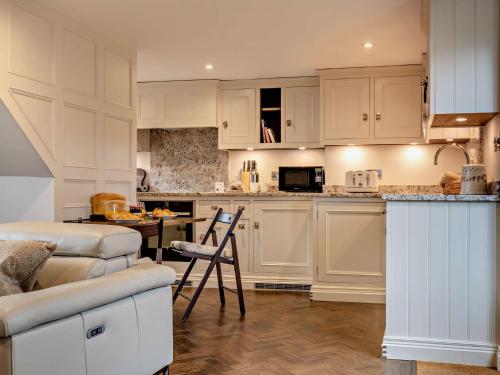 a kitchen with white cabinets and a counter top at 1 Bed in Alderwasley 94394 in Alderwasley