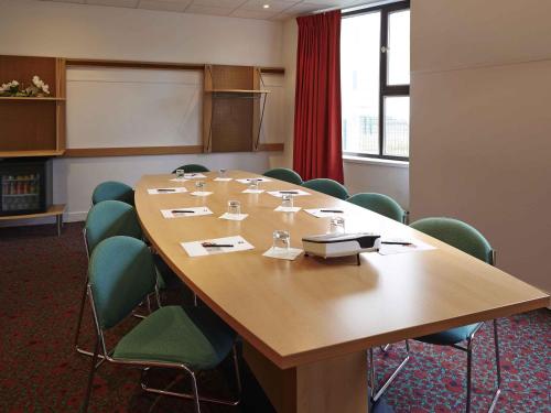 a conference room with a large wooden table and chairs at ibis Strasbourg Centre Historique in Strasbourg