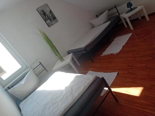 a room with a bed and a couch and a table at Stellas Monteurwohnungen in Crimmitschau