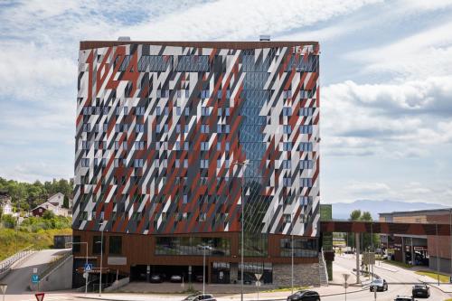 a tall building with many windows on a street at Home Hotel 1624 in Kongsberg