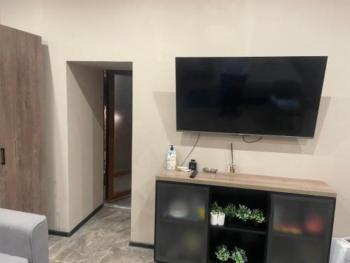 a living room with a flat screen tv on a wall at Номера in Dobrovelychkivka