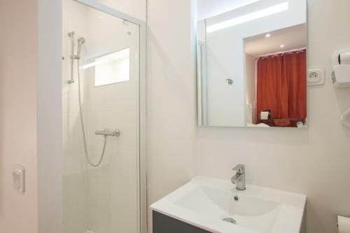 a bathroom with a sink and a shower with a mirror at GAB HOUSE - Lyon Bron - Eurexpo City Living Stay in Bron
