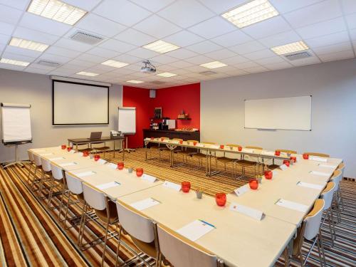 a conference room with tables and chairs in it at Ibis Brussels City Centre in Brussels