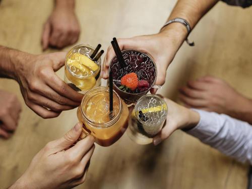 a group of people holding up their drinks at ibis Gent Centrum Opera in Ghent