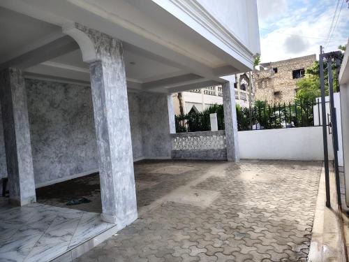 an empty courtyard of a building with columns at The Nest Haven in Malindi