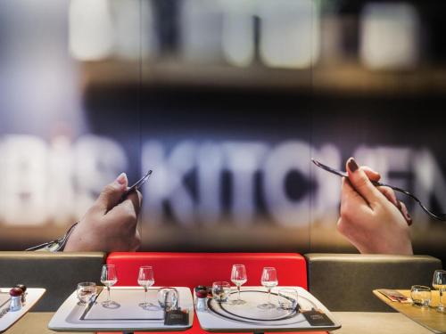 a group of people sitting at a table with their cell phones at ibis Birmingham Centre New Street Station Hotel in Birmingham