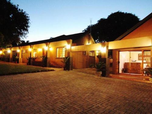 a house with lights on the side of it at Bothabelo Bed and Breakfast in Phalaborwa