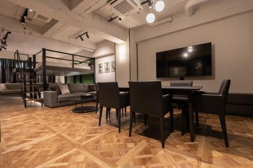 a living room with a table and chairs and a couch at Villa Customa ヴィラカスタマ in Tokyo