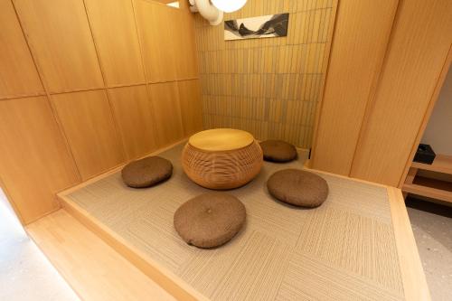 a bathroom with three brown stools on a floor at Villa Customa ヴィラカスタマ in Tokyo