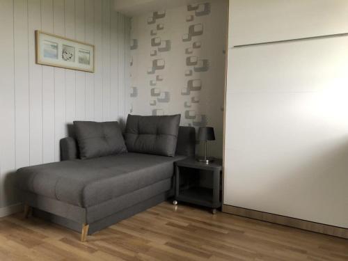 a couch sitting in a room with a table at Marbijes Appartementhaus in Cuxhaven