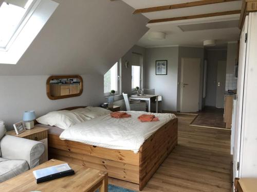 a bedroom with a large bed and a couch at Marbijes Appartementhaus in Cuxhaven