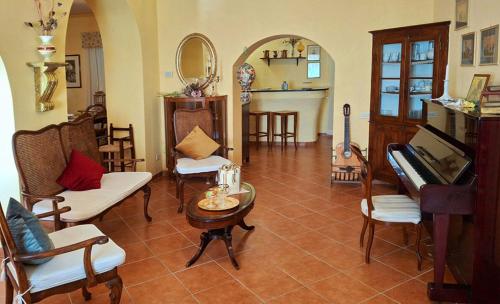 a living room filled with furniture and a piano at La Palazzina in Val d'Orcia in Radicofani