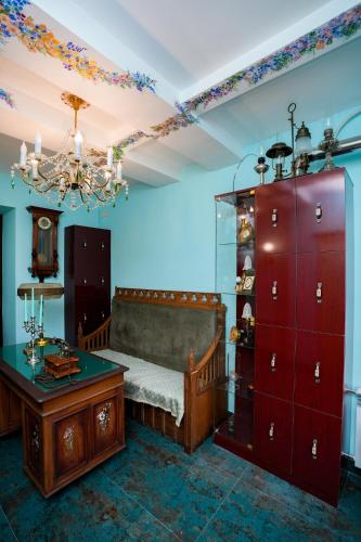 a bedroom with a bed and a table and a chandelier at The Victorian Hotel & Spa Room 1 in Yerevan