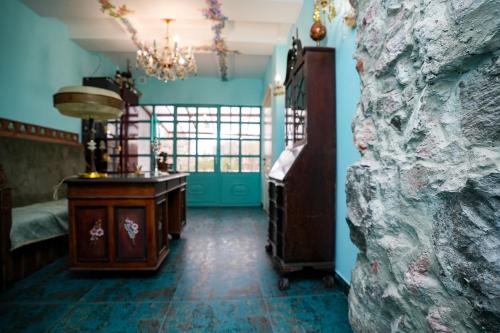 a room with a bed and a table and a chandelier at The Victorian Hotel & Spa Room 1 in Yerevan