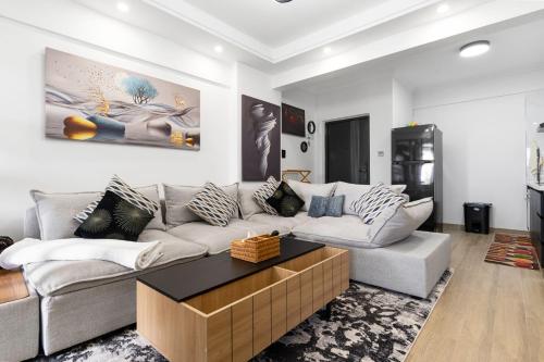a living room with a couch and a coffee table at Lavish condo in Nairobi