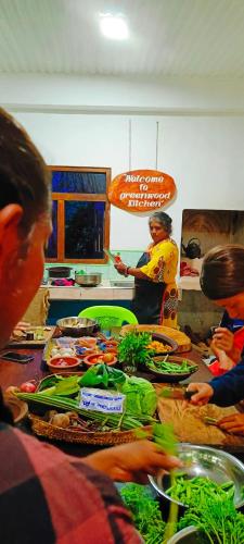 a group of people in a kitchen preparing food at Adisham village home in Haputale