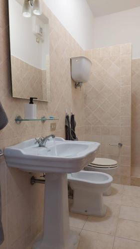 a bathroom with a white sink and a toilet at Vivi in una Torre Medioevale appartamento in Perugia