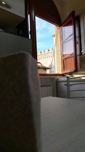a view of a room with a table and a window at Vivi in una Torre Medioevale appartamento in Perugia