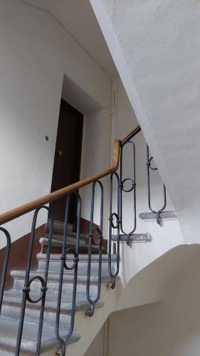 a staircase with metal railings in a building at Vivi in una Torre Medioevale appartamento in Perugia