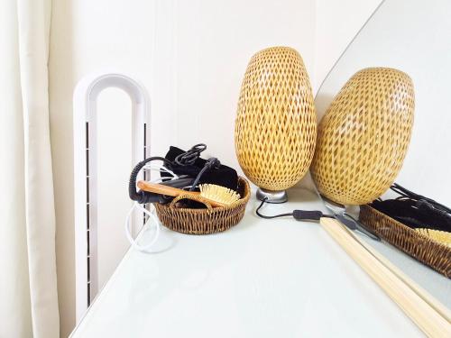 a room with two wicker baskets and a mirror at Stay B in Sŭngch'ŏn-ni